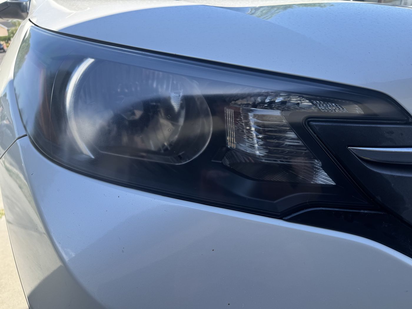 Honda CR-V, heavy chalk-white oxidation after headlight restoration, clear lens