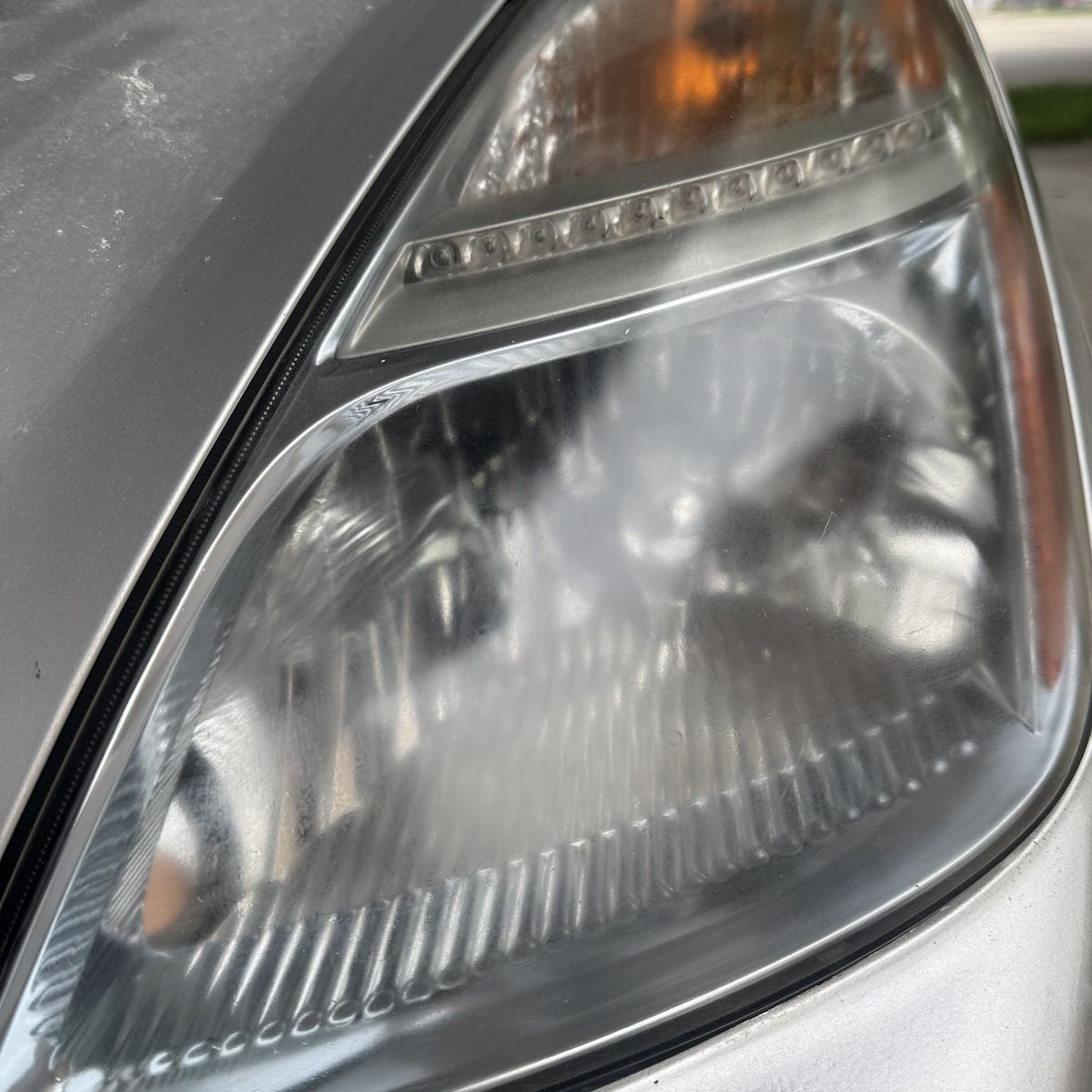 Toyota Prius, cloudy passenger lens after headlight restoration, clear lens